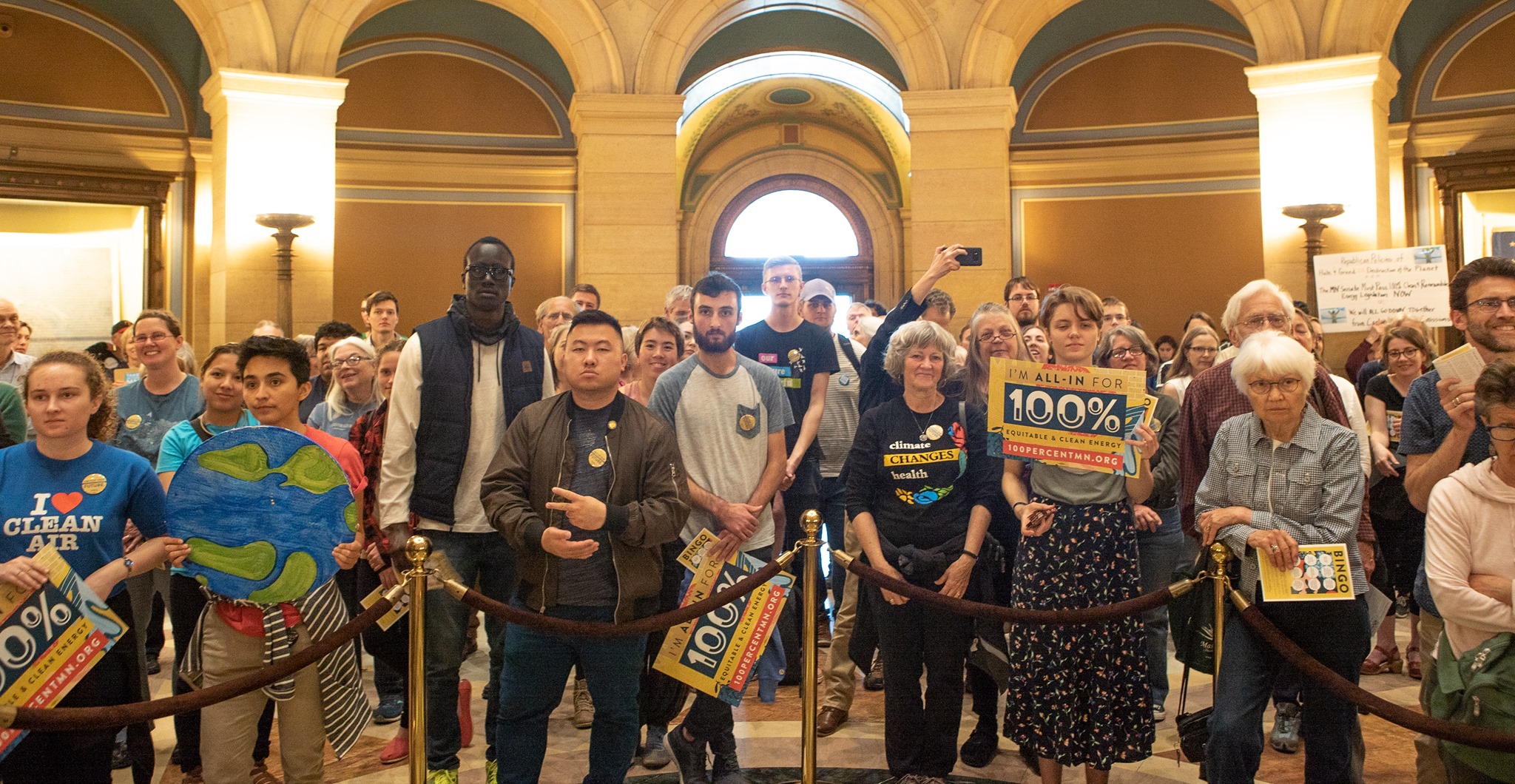 A group of people rallying for climate action at the Minnesota State capitol.