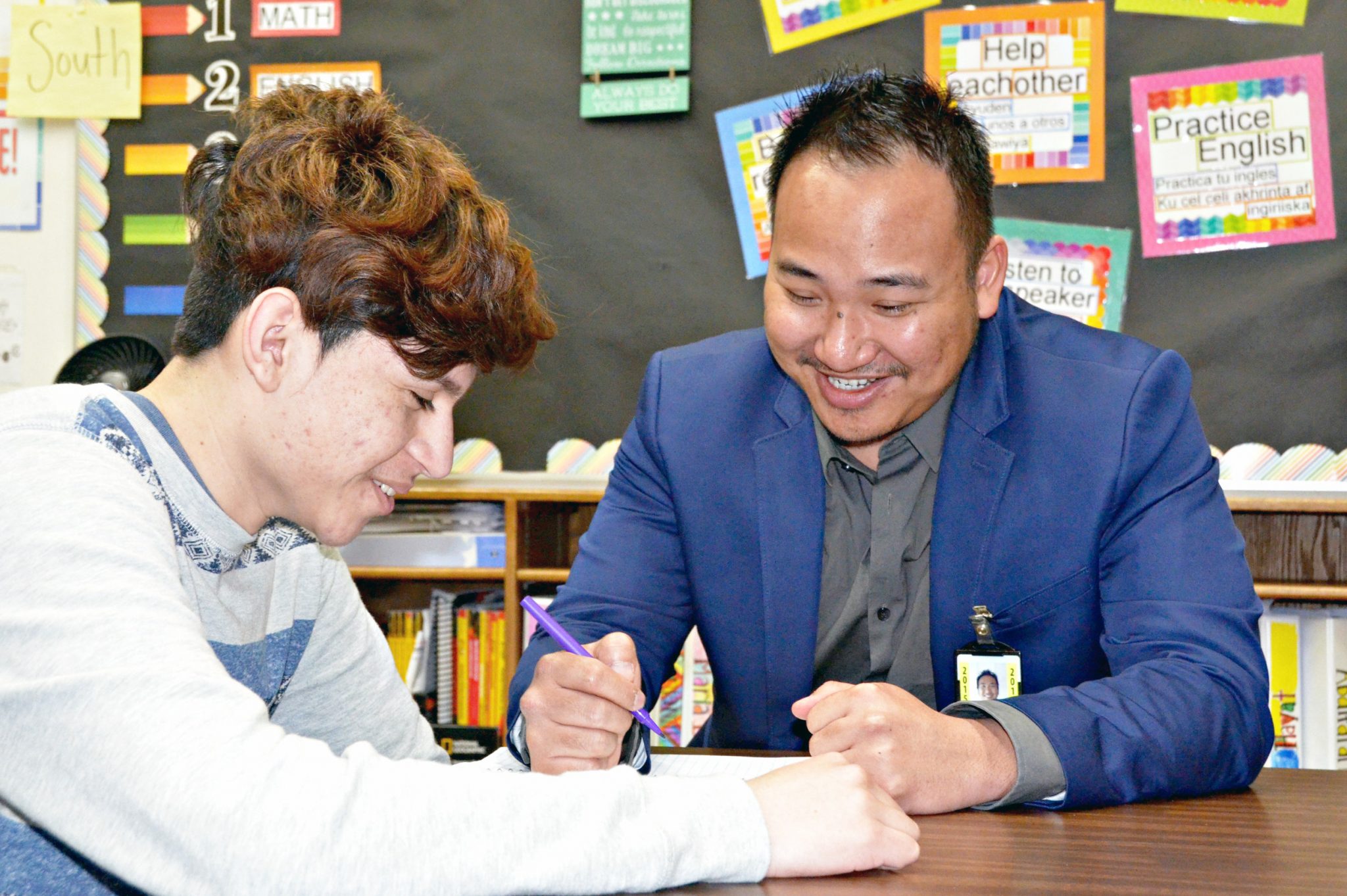 Sam Ouk, an English Language Coordinator for Faribault Public Schools, works with a student.