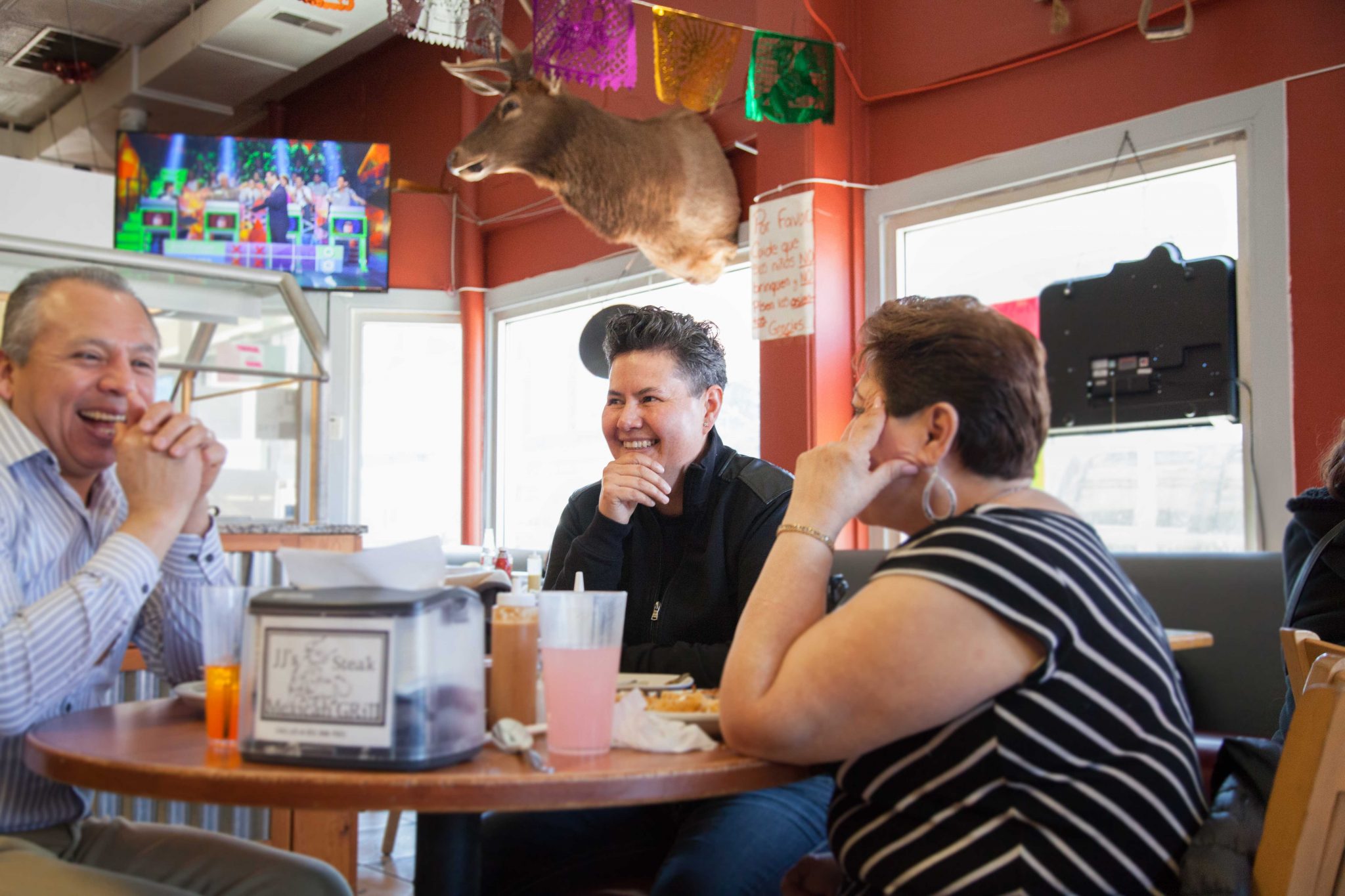 Plaza Del Sol owner Sonia Ortega (center) sits down to chat with customers.