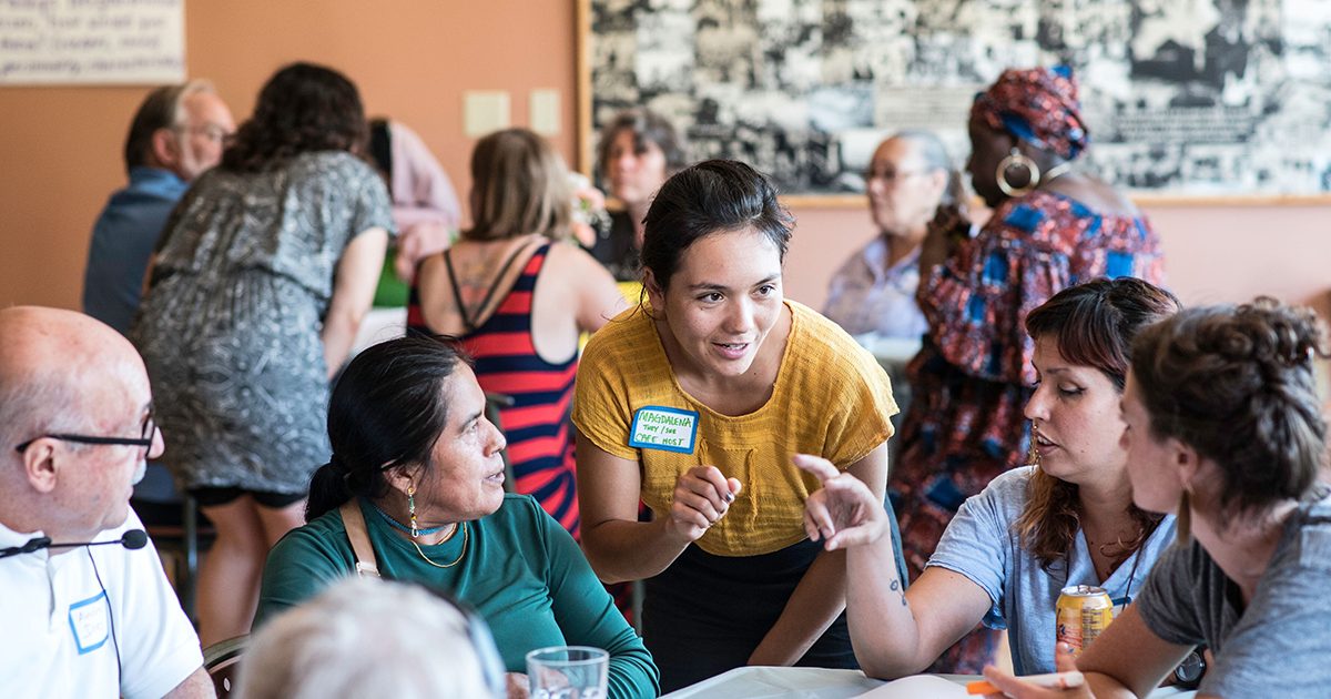 A group of people conversing at a large table